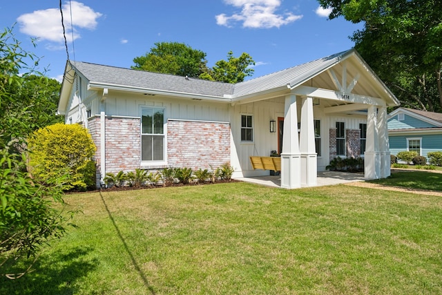 1474 Indian St, Mount Pleasant, SC 29464 - ranch-style house featuring brick siding, a front yard, board and batten siding, and a patio