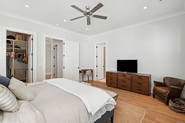 1474 Indian St, Mount Pleasant, SC 29464 - bedroom with light wood-style floors, crown molding, a spacious closet, recessed lighting, and a closet