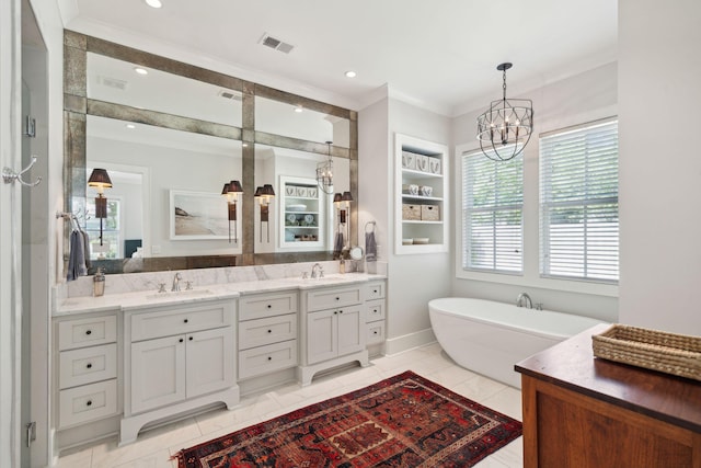 1474 Indian St, Mount Pleasant, SC 29464 - bathroom with a freestanding bath, double vanity, a chandelier, ornamental molding, and recessed lighting