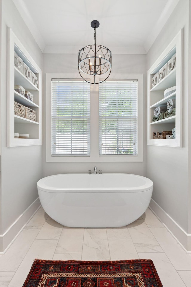 1474 Indian St, Mount Pleasant, SC 29464 - bathroom with marble finish floors, healthy amount of natural light, a chandelier, a soaking tub, and ornamental molding
