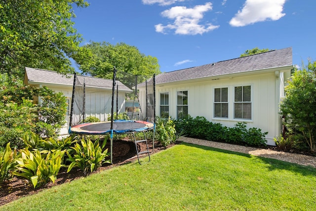 1474 Indian St, Mount Pleasant, SC 29464 - rear view of property with a trampoline, a lawn, and roof with shingles