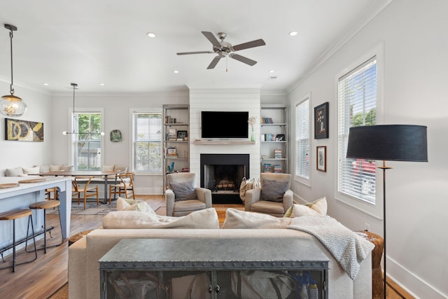 1474 Indian St, Mount Pleasant, SC 29464 - living area with light wood-style floors, a fireplace, ceiling fan, baseboards, and crown molding