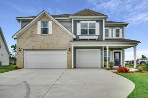 view of front of property with covered porch, concrete driveway, and an attached garage