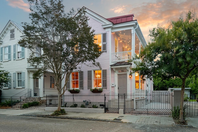 multi unit property featuring a fenced front yard and a balcony