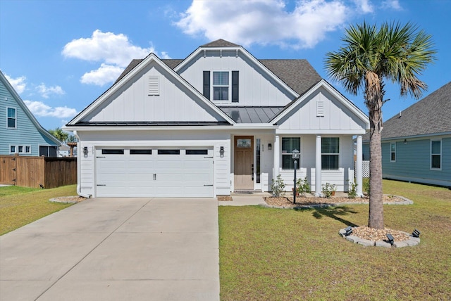 view of front of home featuring a porch, a front lawn, and a garage