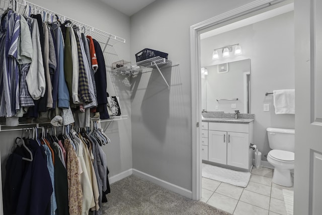 walk in closet featuring light tile patterned floors and sink