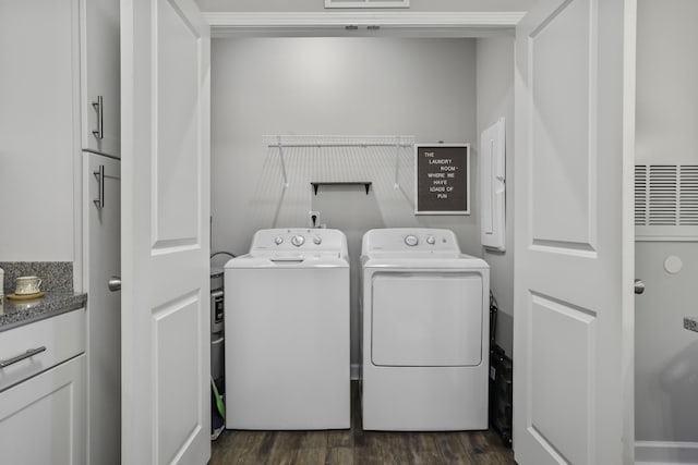 clothes washing area with dark hardwood / wood-style flooring and washing machine and clothes dryer