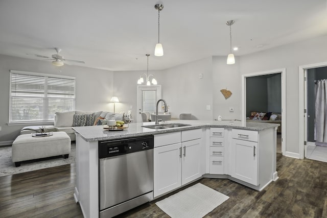 kitchen with dishwasher, decorative light fixtures, white cabinetry, sink, and a center island with sink