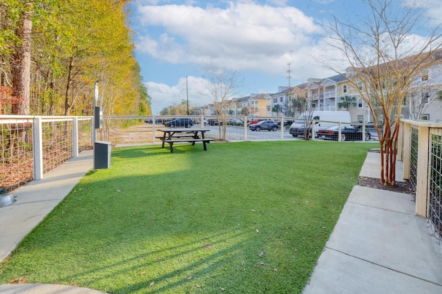 view of property's community with a yard