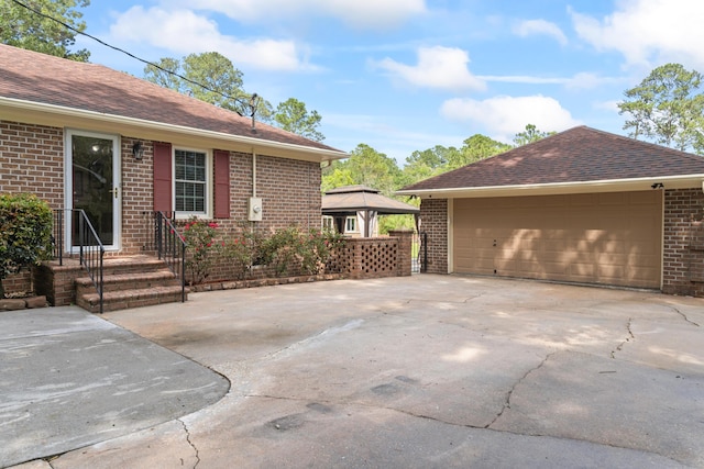 1551 Hutton Pl, Charleston, SC 29407 - view of property exterior with brick siding, a gazebo, a garage, and a shingled roof
