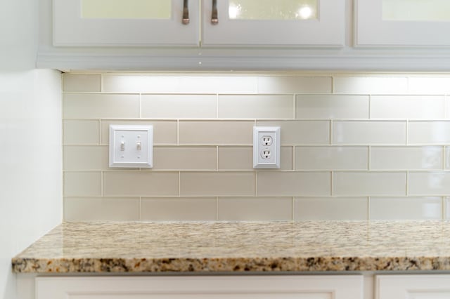 1551 Hutton Pl, Charleston, SC 29407 - detailed view of tasteful backsplash, light stone counters, and white cabinets