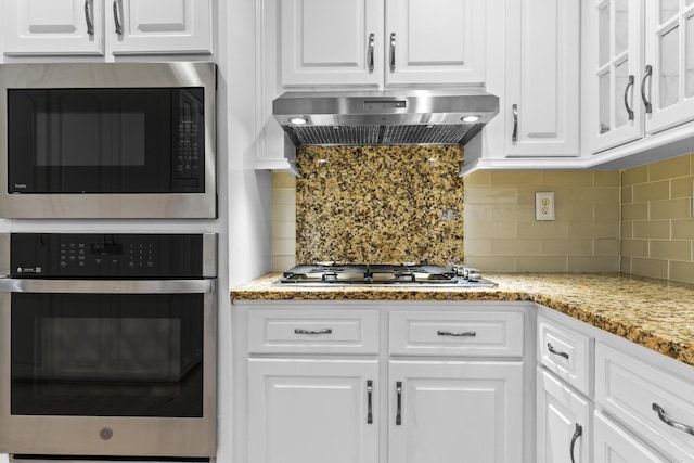 1551 Hutton Pl, Charleston, SC 29407 - kitchen with stainless steel appliances, exhaust hood, white cabinetry, and backsplash