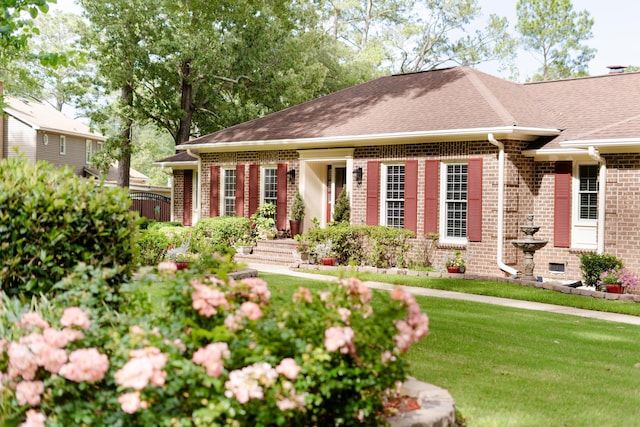1551 Hutton Pl, Charleston, SC 29407 - view of front facade featuring brick siding, a front lawn, and a shingled roof