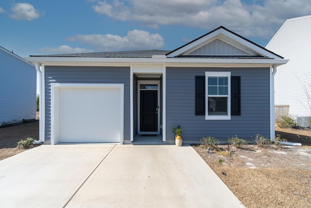 view of front of house with a garage and central air condition unit