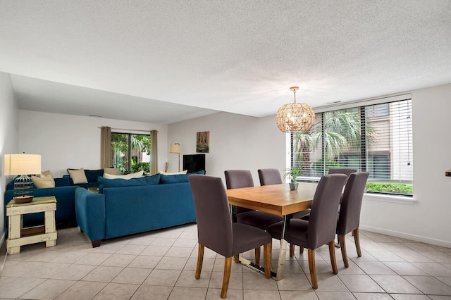 dining room featuring light tile patterned floors, a textured ceiling, and a chandelier