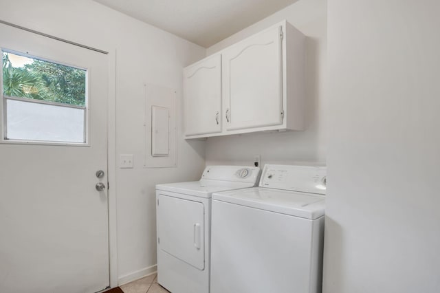 washroom with light tile patterned flooring, cabinets, and separate washer and dryer