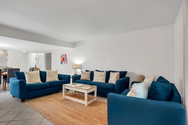 tiled living room featuring a textured ceiling