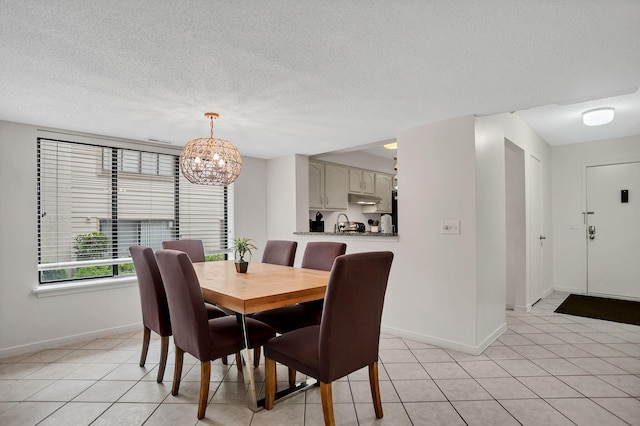 tiled dining room featuring a textured ceiling and a notable chandelier