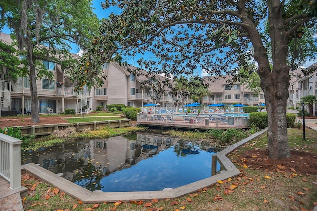 view of pool featuring a water view