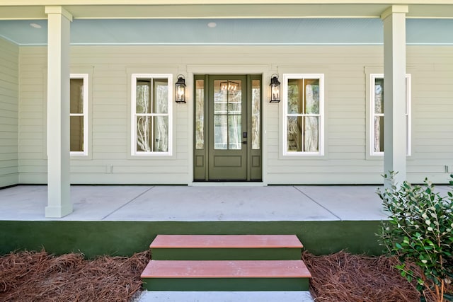 view of exterior entry featuring a porch