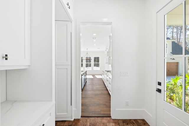 hall featuring recessed lighting, dark wood-style flooring, and baseboards