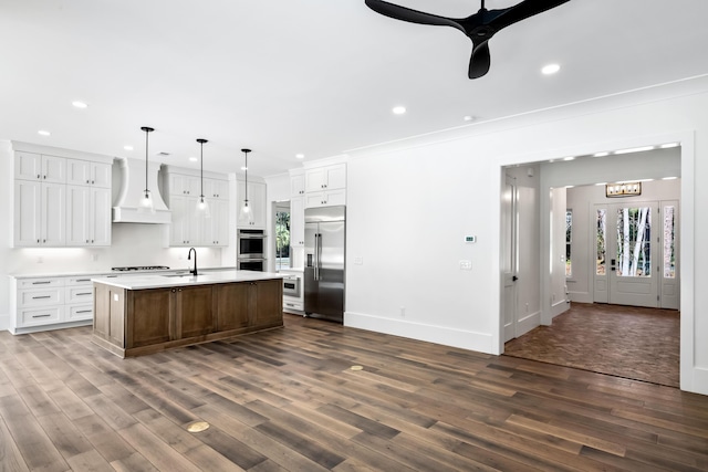 kitchen featuring appliances with stainless steel finishes, light countertops, crown molding, premium range hood, and recessed lighting