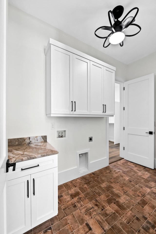 laundry area featuring ceiling fan, hookup for an electric dryer, washer hookup, baseboards, and cabinet space