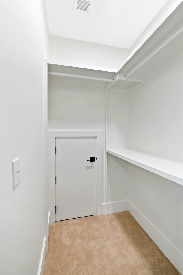 spacious closet with light carpet and visible vents