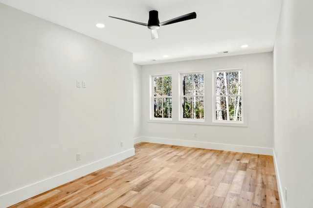 spare room featuring light wood-type flooring, ceiling fan, baseboards, and recessed lighting