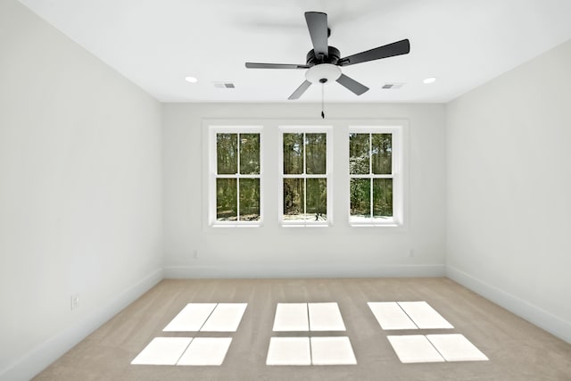 empty room featuring baseboards, visible vents, and recessed lighting