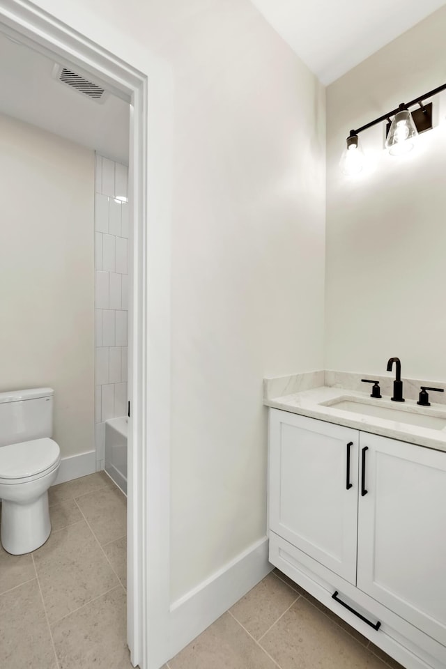 full bathroom with toilet, vanity, baseboards, visible vents, and tile patterned floors