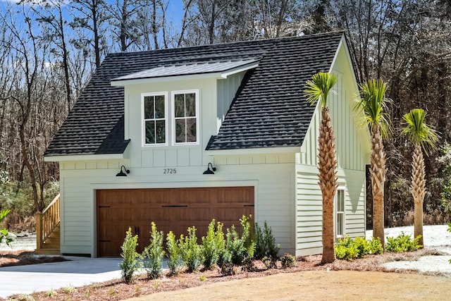 view of property exterior with board and batten siding and roof with shingles