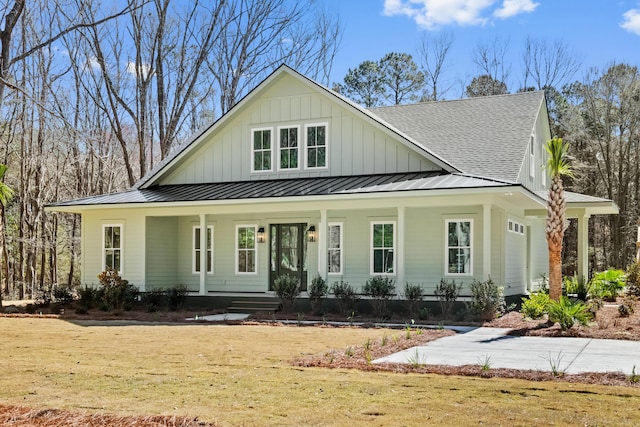 view of front facade with a standing seam roof, a porch, board and batten siding, and a shingled roof