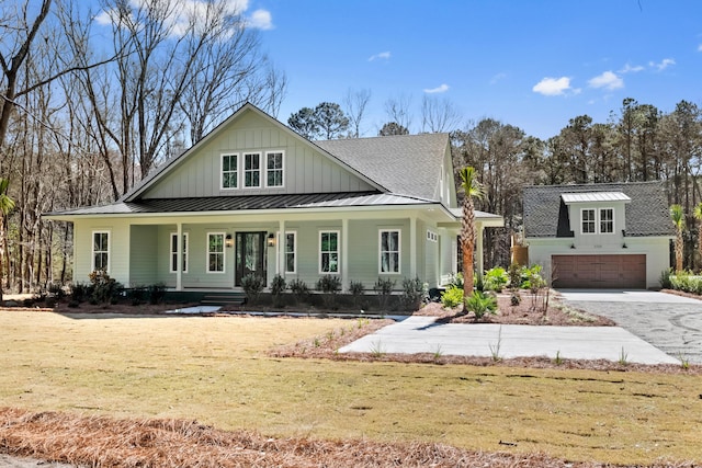 view of front of house with a porch, a shingled roof, board and batten siding, a standing seam roof, and a garage