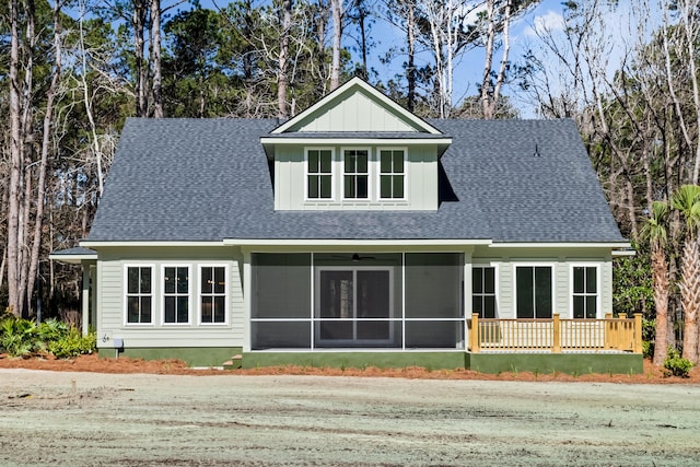 view of front of house with a shingled roof, board and batten siding, and a sunroom