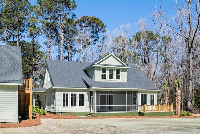 back of property featuring roof with shingles and a sunroom