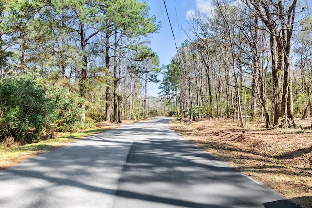 view of road featuring a forest view