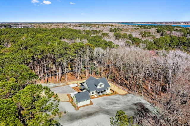 birds eye view of property featuring a view of trees