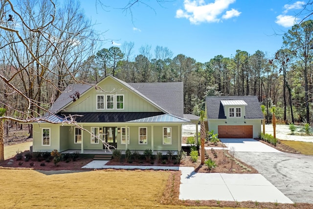 view of front of property featuring a porch, board and batten siding, a front yard, a standing seam roof, and metal roof