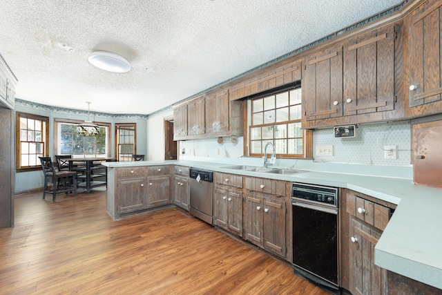 200 Old Postern Rd, Summerville, SC 29483 - kitchen featuring dishwasher, a sink, a peninsula, wood finished floors, and a textured ceiling