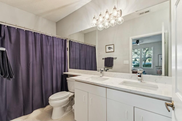 bathroom featuring double vanity, visible vents, toilet, a sink, and ensuite bath