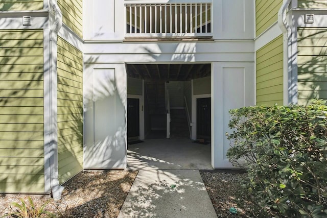 view of exterior entry with a balcony