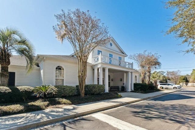 greek revival inspired property featuring a balcony