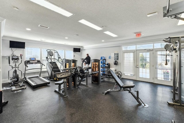 exercise room featuring a textured ceiling, visible vents, baseboards, french doors, and ornamental molding