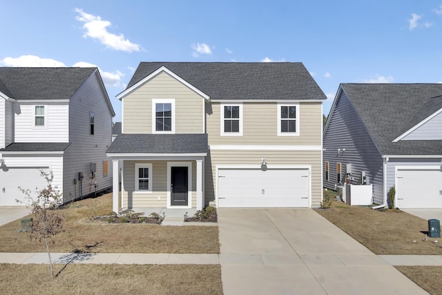 traditional-style home with a garage, a shingled roof, and concrete driveway