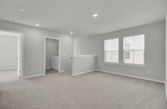 spare room featuring recessed lighting, visible vents, light carpet, and separate washer and dryer