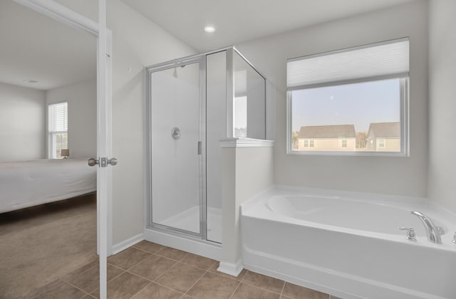 full bath with a garden tub, baseboards, tile patterned floors, a stall shower, and ensuite bath