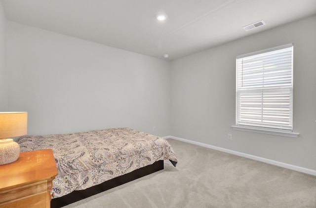 bedroom with light carpet, recessed lighting, visible vents, and baseboards