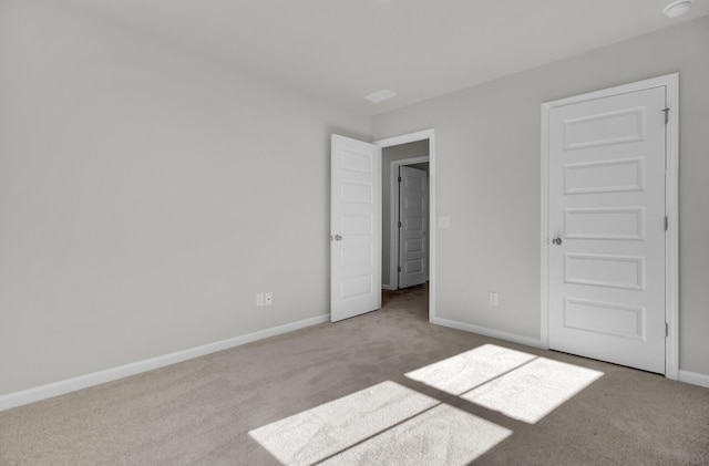 unfurnished bedroom featuring baseboards and light colored carpet