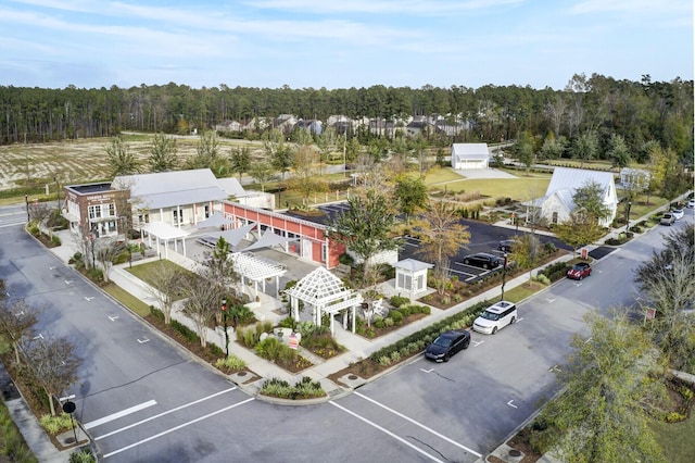 drone / aerial view featuring a wooded view